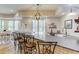 Finished basement wet bar with stone counter, seating for five, and open view to basement dining area at 2400 Weber Heights Way, Buford, GA 30519