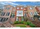 Multi-story townhomes featuring brick facades, black shutters, and landscaped front yards at 2602 Brookhaven Chase Ne Ln, Brookhaven, GA 30319