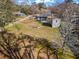 Aerial view of property featuring a large grassy yard, storage shed, and outdoor seating at 4493 Old Hiram Lithia Spgs Rd, Powder Springs, GA 30127