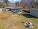 Spacious backyard with a fire pit, above ground pool, and ample space for outdoor enjoyment and entertaining at 4493 Old Hiram Lithia Spgs Rd, Powder Springs, GA 30127