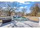 Spacious backyard featuring a large deck, above ground pool, storage unit, and mature trees at 4493 Old Hiram Lithia Spgs Rd, Powder Springs, GA 30127
