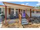 Welcoming front porch featuring cozy seating, decorative elements, and well-maintained landscaping at 4493 Old Hiram Lithia Spgs Rd, Powder Springs, GA 30127