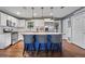 Bright eat-in kitchen features a center island, stainless steel appliances and lots of white cabinets at 4493 Old Hiram Lithia Spgs Rd, Powder Springs, GA 30127
