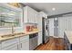 Bright kitchen features stainless steel appliances, granite countertops and white cabinets at 4493 Old Hiram Lithia Spgs Rd, Powder Springs, GA 30127