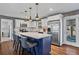 Modern kitchen with a large island, stainless steel appliances, and a seamless transition to the living area at 4493 Old Hiram Lithia Spgs Rd, Powder Springs, GA 30127