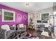 Inviting living room featuring plush seating, a stylish purple accent wall, and a modern work space at 4493 Old Hiram Lithia Spgs Rd, Powder Springs, GA 30127