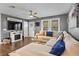 Inviting living room featuring a cozy sectional, decorative fireplace, and a view of the adjacent dining area at 4493 Old Hiram Lithia Spgs Rd, Powder Springs, GA 30127