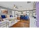 Open-concept living room with hardwood floors, modern decor, and a seamless flow into the kitchen at 4493 Old Hiram Lithia Spgs Rd, Powder Springs, GA 30127