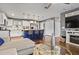 Open-concept living room with a view of the kitchen, a comfortable sofa, and stylish accents at 4493 Old Hiram Lithia Spgs Rd, Powder Springs, GA 30127