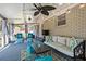 Bright sunroom furnished with comfortable seating, a ceiling fan, and views of the backyard at 4493 Old Hiram Lithia Spgs Rd, Powder Springs, GA 30127