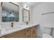Luxurious bathroom featuring double sinks, modern fixtures, and a decorative accent wall at 926 Natham Dr, Atlanta, GA 30315