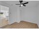 Minimalist bedroom with hardwood floors and ceiling fan, adjacent to another room at 926 Natham Dr, Atlanta, GA 30315