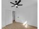 Bedroom featuring white walls, light wood floors, a ceiling fan and a closet with white doors at 926 Natham Dr, Atlanta, GA 30315