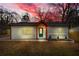 Charming renovated single-story home with a teal front door and fresh landscaping against a twilight sky at 926 Natham Dr, Atlanta, GA 30315