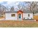 Charming single-story home featuring white siding, brick accents, and a vibrant blue front door at 926 Natham Dr, Atlanta, GA 30315