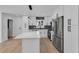 Open concept kitchen with stone countertops, stainless steel appliances and grey backsplash at 926 Natham Dr, Atlanta, GA 30315