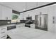 Newly renovated kitchen boasts stone countertops, gray backsplash, and stainless appliances at 926 Natham Dr, Atlanta, GA 30315