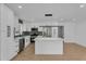 Modern kitchen with stainless steel appliances, island, custom backsplash, and sleek cabinetry at 926 Natham Dr, Atlanta, GA 30315