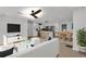 Bright open-concept living room featuring hardwood floors, modern decor, and seamless flow to kitchen and dining area at 926 Natham Dr, Atlanta, GA 30315
