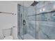 Shower room featuring teal tile walls, glass doors, and gold fixtures and hardware at 926 Natham Dr, Atlanta, GA 30315