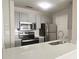 Kitchen featuring stainless steel appliances, gray cabinets, and a white countertop at 1074 Peachtree Sw Walk # B 216, Atlanta, GA 30309