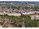 Aerial view showcasing nearby commercial buildings and roadways with surrounding green areas and trees at 134 Jacobs Ln, Loganville, GA 30052