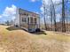 View of the home's backyard featuring a screened in porch and mature trees at 134 Jacobs Ln, Loganville, GA 30052