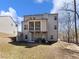 Spacious backyard with a screened porch, a lower level patio, and a gentle slope at 134 Jacobs Ln, Loganville, GA 30052