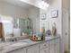 Bathroom with granite countertops, double vanity, and framed mirrors at 134 Jacobs Ln, Loganville, GA 30052