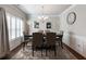 Elegant dining room with hardwood floors, wainscoting, large windows, and a stylish chandelier at 134 Jacobs Ln, Loganville, GA 30052