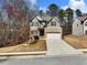 Charming two-story home with stone accents, a well-manicured lawn, and an attached two-car garage at 134 Jacobs Ln, Loganville, GA 30052