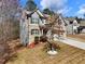 Beautiful two-story home with a stone and gray shingle exterior, well-kept lawn, and mature trees at 134 Jacobs Ln, Loganville, GA 30052