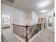 Hallway with chandelier, carpet, and neutral paint, adjacent to bedrooms at 134 Jacobs Ln, Loganville, GA 30052