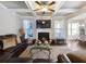 Cozy living room with coffered ceilings, a fireplace, a leather sofa, and ample natural light at 134 Jacobs Ln, Loganville, GA 30052