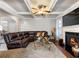 Comfortable living room with hardwood floors, a leather sofa, a fireplace, and coffered ceilings at 134 Jacobs Ln, Loganville, GA 30052