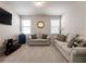 Living room with a cozy seating area and windows with wood blinds at 134 Jacobs Ln, Loganville, GA 30052