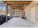 Covered patio with wood beams and concrete flooring, leading to yard at 134 Jacobs Ln, Loganville, GA 30052