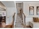 Carpeted staircase featuring wood railing and decorative iron balusters leading to the upper level at 134 Jacobs Ln, Loganville, GA 30052