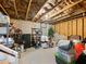 A cluttered unfinished basement with cement flooring and insulation exposed at 134 Jacobs Ln, Loganville, GA 30052