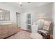 Bedroom with changing table, rocking chair, and natural light at 2793 Frontier Trl, Atlanta, GA 30341