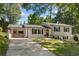 Charming home with white siding, black shutters, a red front door and a well-maintained front lawn at 2793 Frontier Trl, Atlanta, GA 30341