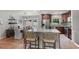 Open kitchen and dining area featuring hardwood floors and a granite island with barstool seating at 2793 Frontier Trl, Atlanta, GA 30341