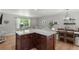 Open-concept kitchen island with seating and granite countertops, next to the living room and dining area at 2793 Frontier Trl, Atlanta, GA 30341