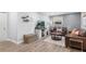 Cozy living room with hardwood floors, leather sofas, decorative shelving, and a modern entertainment center at 2793 Frontier Trl, Atlanta, GA 30341