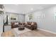 Living room featuring hardwood floors, leather couches, and two windows at 2793 Frontier Trl, Atlanta, GA 30341