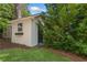 Exterior view of the backyard shed, complemented by lush greenery and manicured lawn at 2793 Frontier Trl, Atlanta, GA 30341