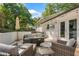 Beautiful patio with outdoor seating around a fire pit, TV, and string lights for evening enjoyment at 2793 Frontier Trl, Atlanta, GA 30341