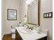 Powder room features a modern sink and decorative mirror at 320 Morganshire Pl, Atlanta, GA 30350