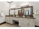 This bathroom offers a vanity with double sinks, granite counters, and custom cabinets at 320 Morganshire Pl, Atlanta, GA 30350