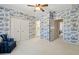 Bedroom with patterned wallpaper, a ceiling fan and an open doorway to a bathroom at 320 Morganshire Pl, Atlanta, GA 30350